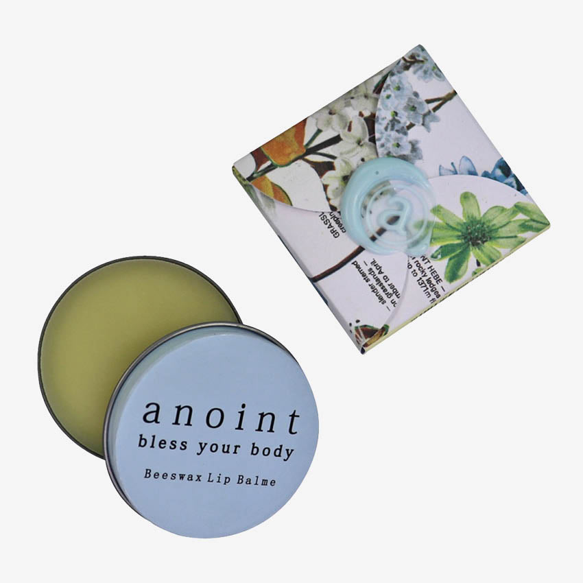 The Anoint Bees Wax Lip Balm and its packaging on a blank background