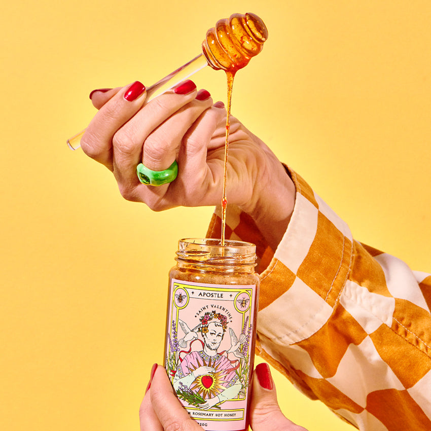 The Apostle Saint Valentine Hot Honey dripping off a spoon into the jar