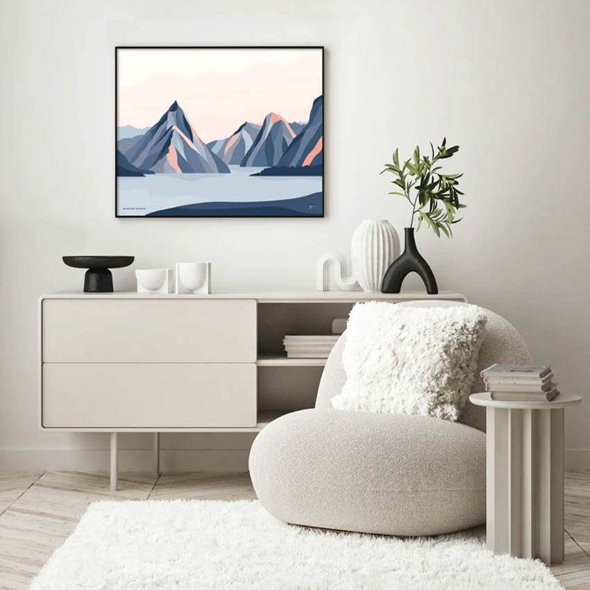 The Bridget Hall Milford Sound Art Print in a black frame hanging in a living room