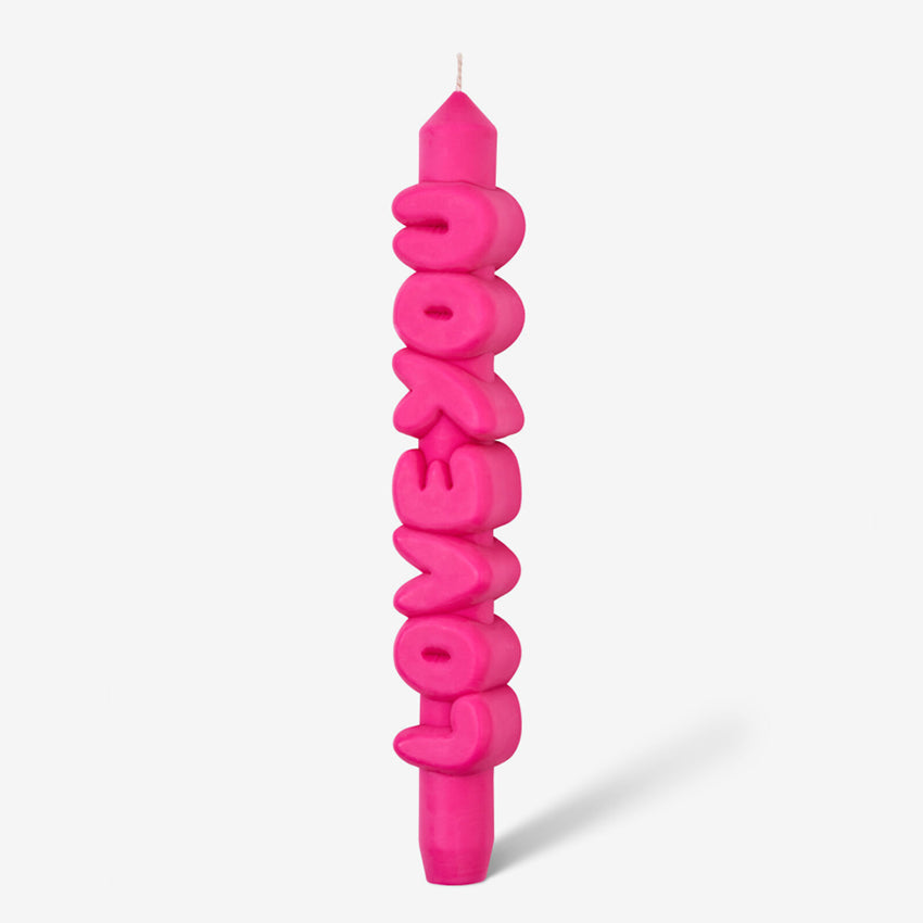 The CandleHand Love You 3D Taper Candle in pink on a grey background