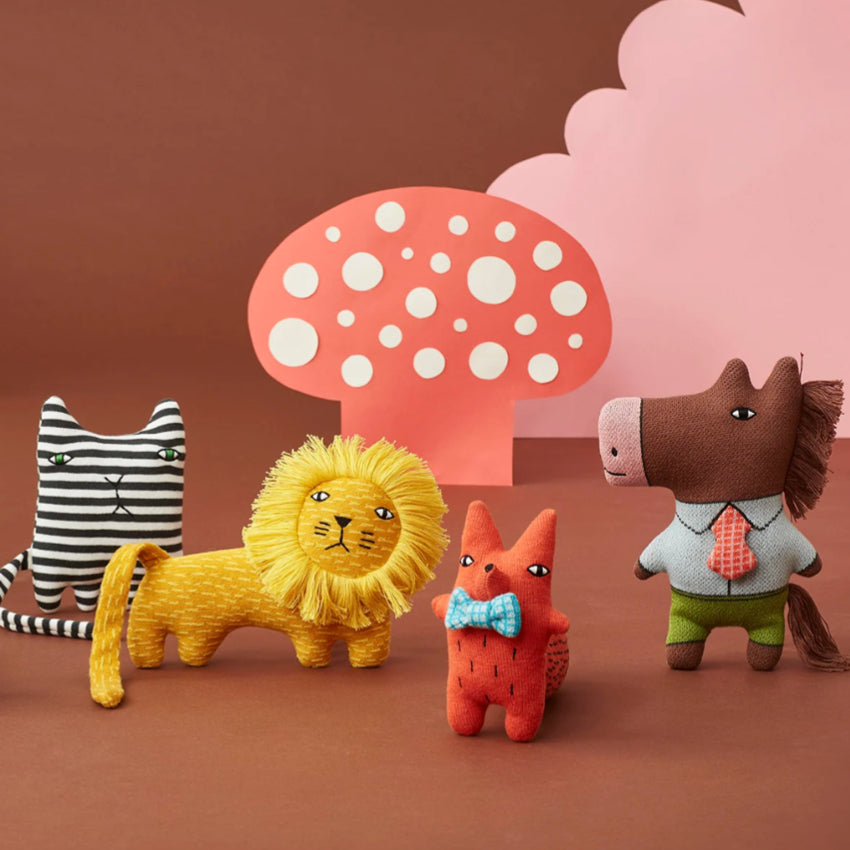 The Donna Wilson Wee Ones on a brown background with cutouts