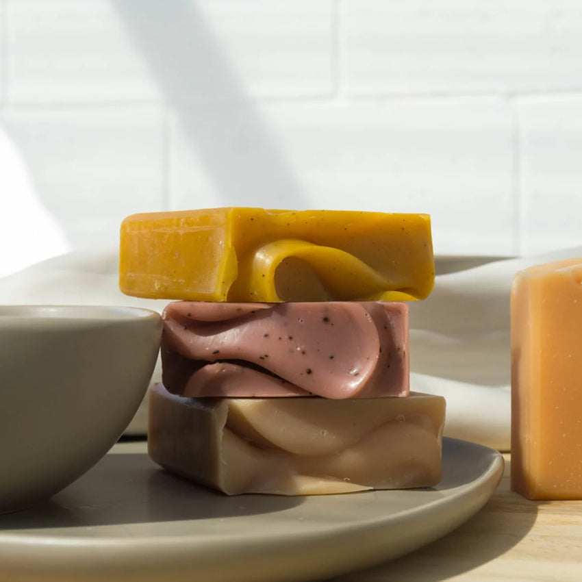 Three of the Fair + Square soap bars stacked on a plate