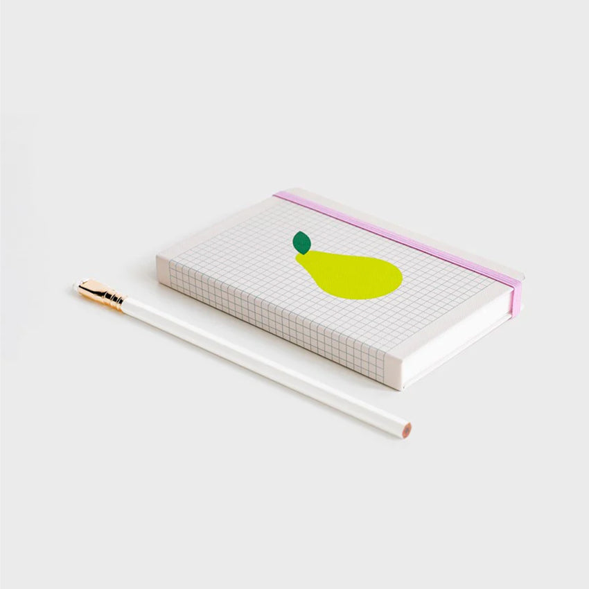 The Lettuce Pear Hardcover Notebook on a blank background next to a pencil