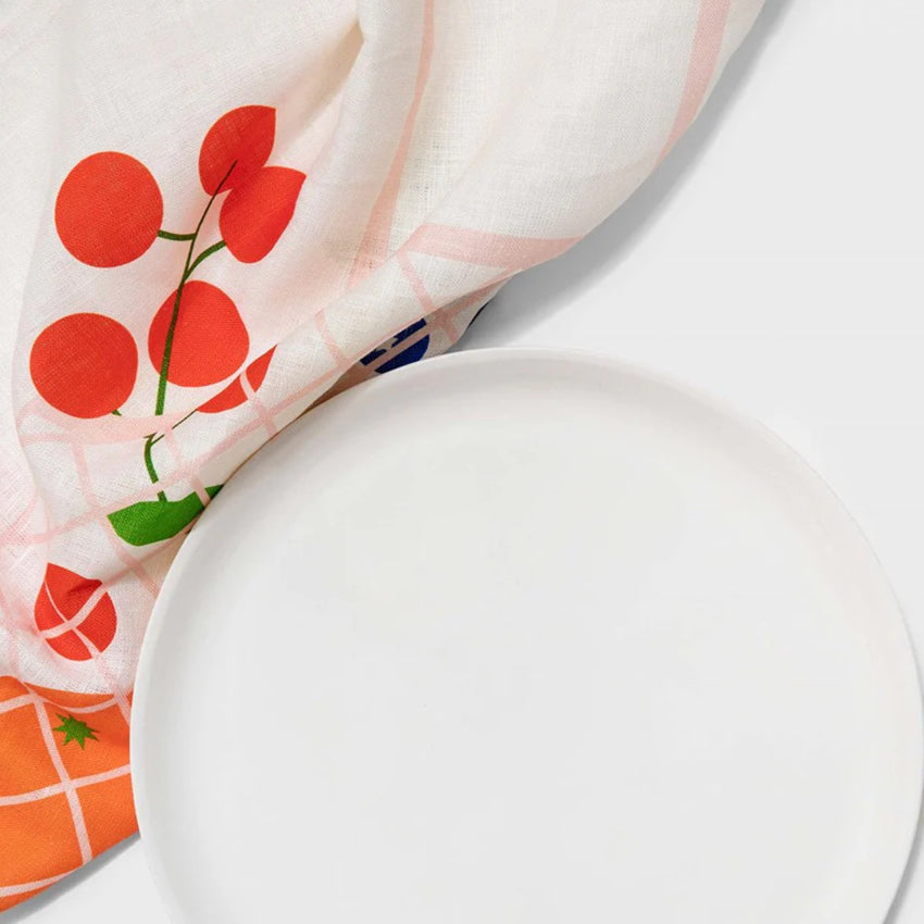 The Lettuce Market Bag Tea Towel under a white plate