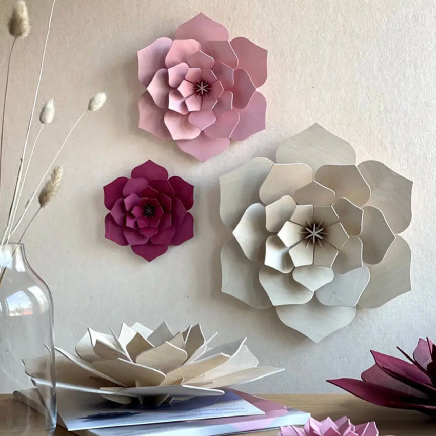 The Lovi 3D Flower Decor in Light Pink hanging on a wall with other coloured 3D Flowers
