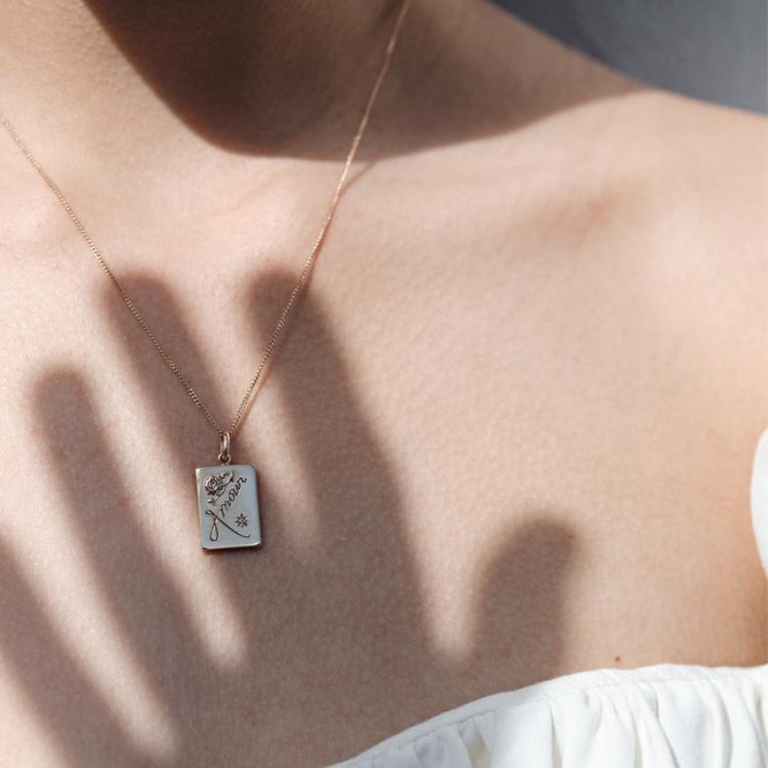 The Meadowlark Amour Necklance with a Pink Sapphire in Sterling Silver on a model.