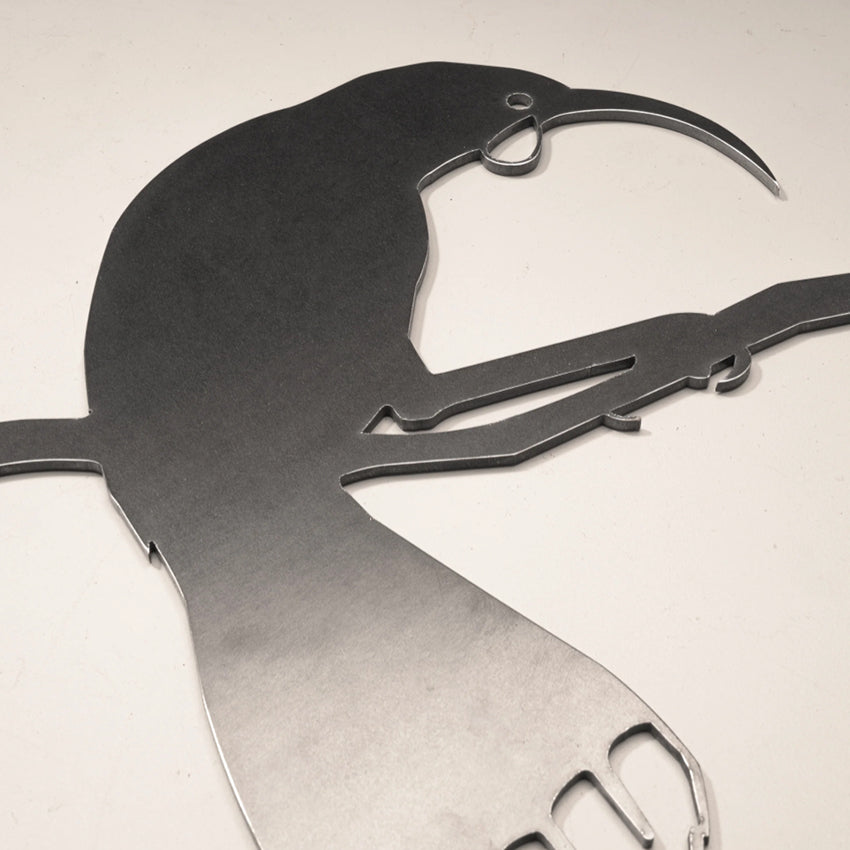 A closeup of the Metalbird Huia Garden Sculpture on a blank background