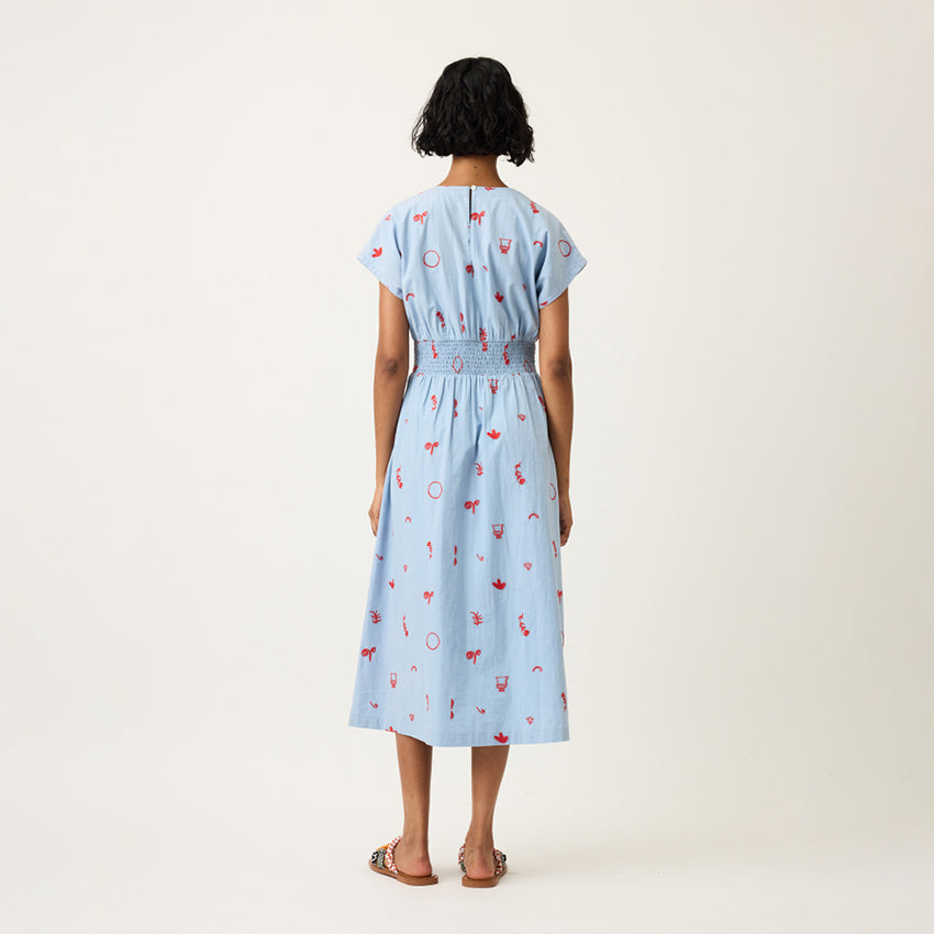 A back view of the Nancybird Hana Dress in Motif Embroidery on a model