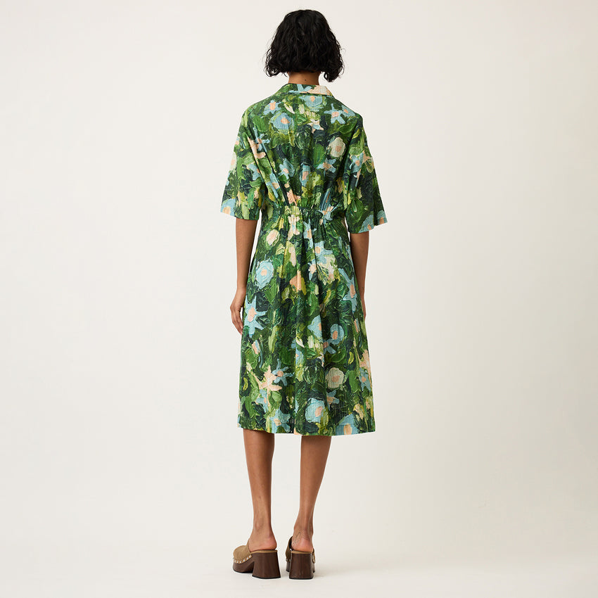 A back view of the Nancybird Paloma Short Sleeve Dress in Garden print on a model
