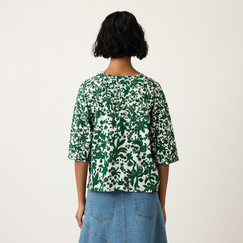 A back view of the Nancybird Tasmin Boxy Tee in Parsley on a model