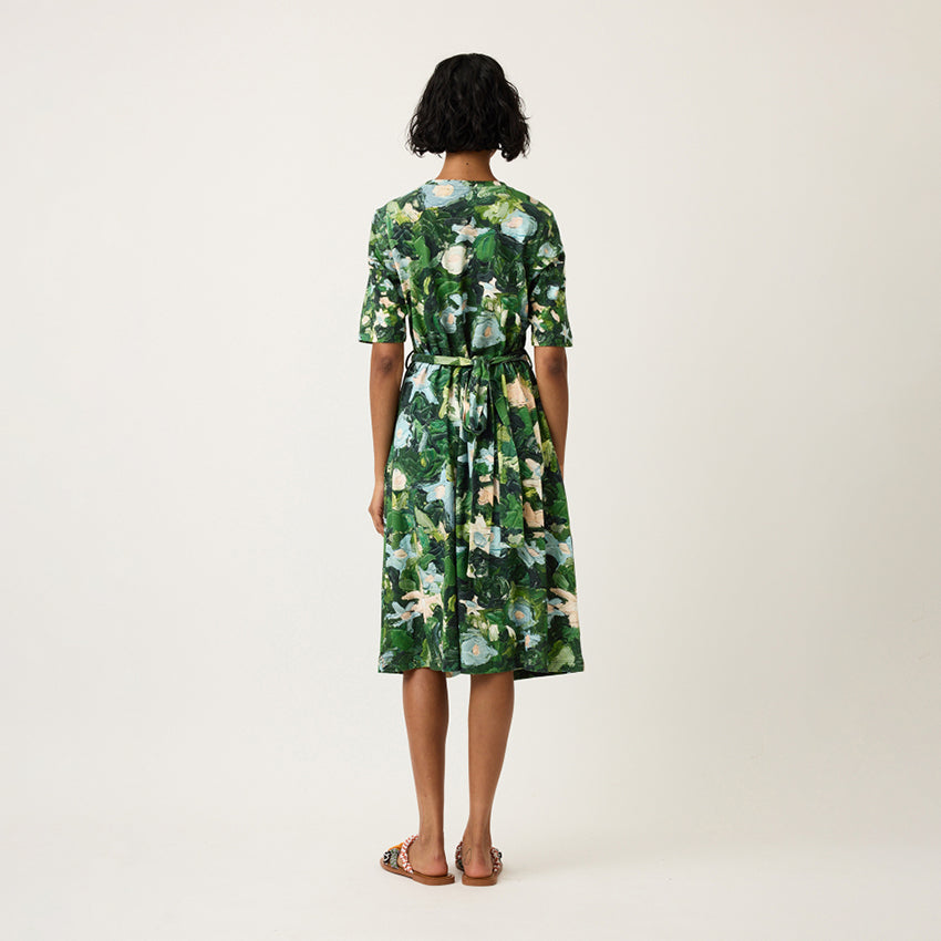 A back view of the Nancybird Terra Short Sleeve Wrap Dress in Garden on a model