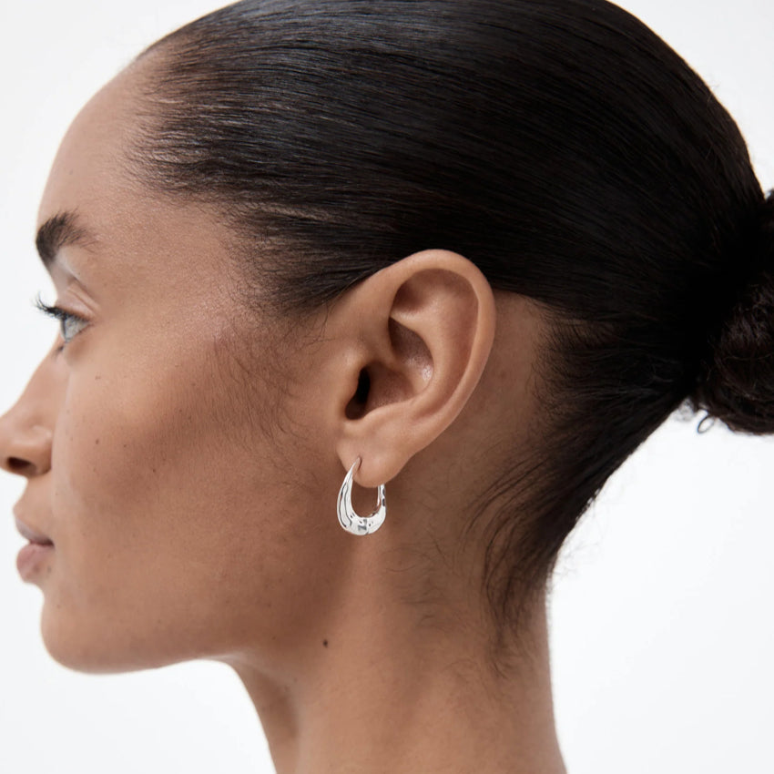 The Nina Gordon Dajia Hoop in Small Sterling Silver on a model