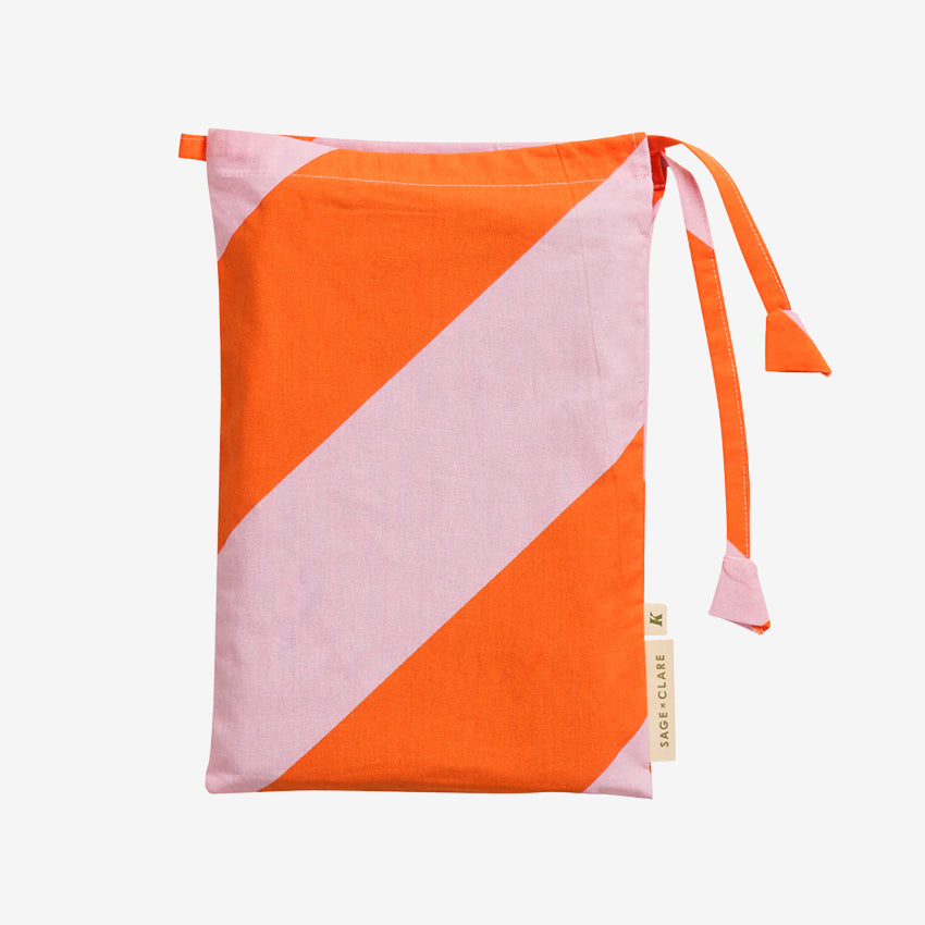 The bag for the Sage x Clare Clarice Cotton Pillowcase on a grey background