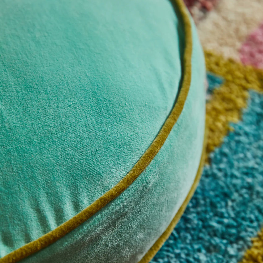 A closeup of the Sage x Clare Etienne Velvet Floor Cushion in Jade