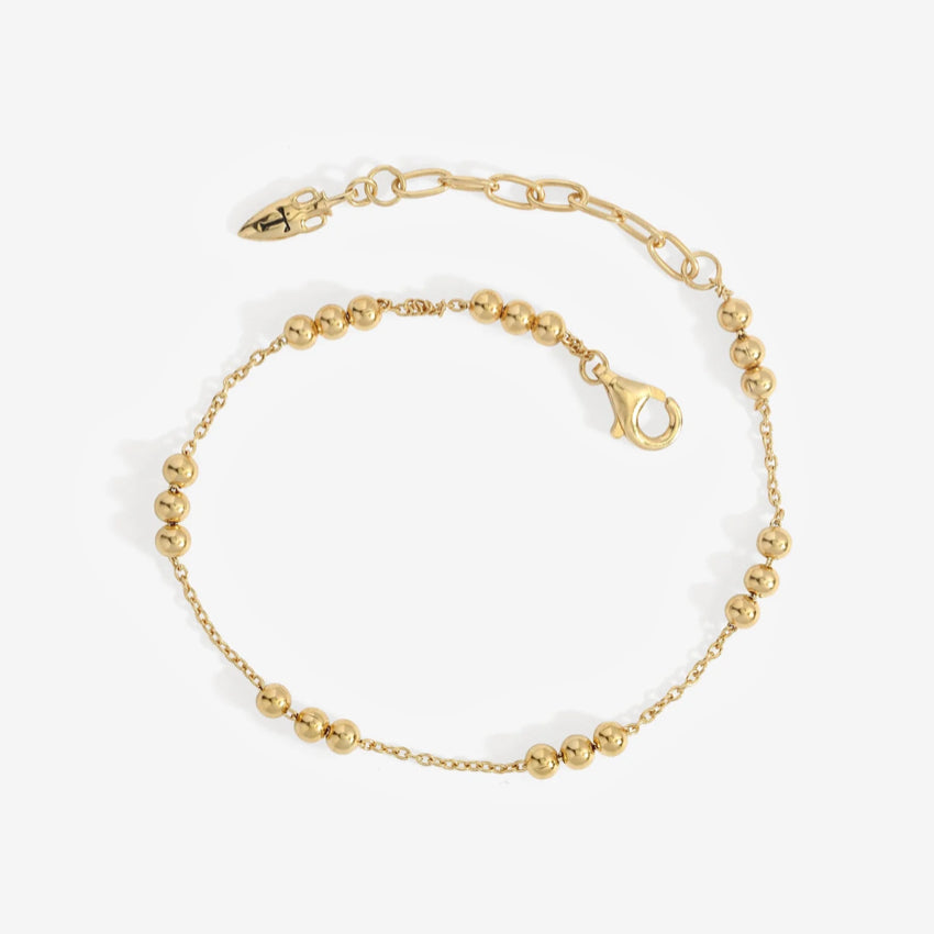 The Temple Of The Sun Alba Station Bracelet in Gold on a grey background