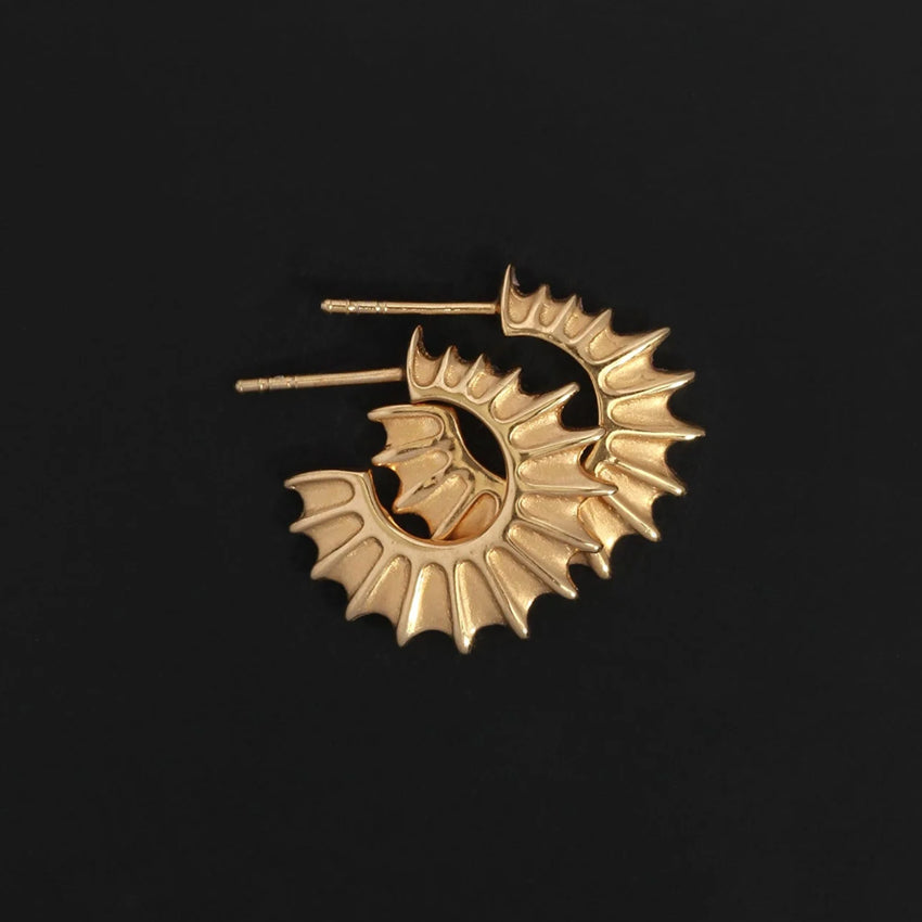 The Temple Of The Sun Calypso Hoops in Gold Vermeil on a black background