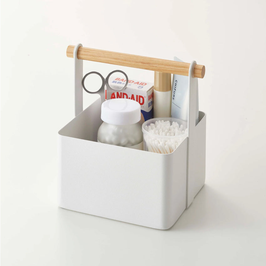The Yamazaki Small Tosca Tool Box on a blank background with bathroom items in it