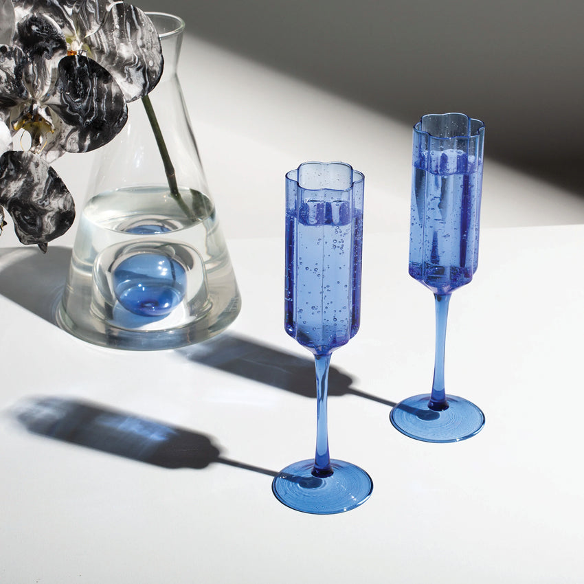 The Fazeek Wave Flutes in Blue next to a fazeek vase with a flower in it