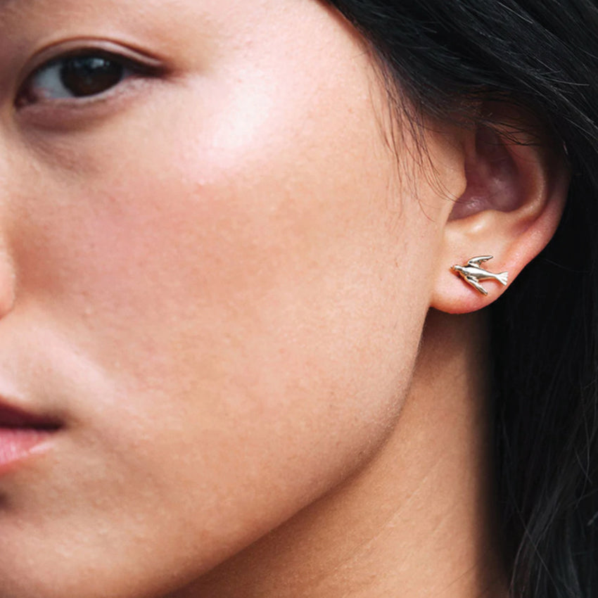 The Meadowlark Bee Signature Hoops in Sterling Silver on a models ear.