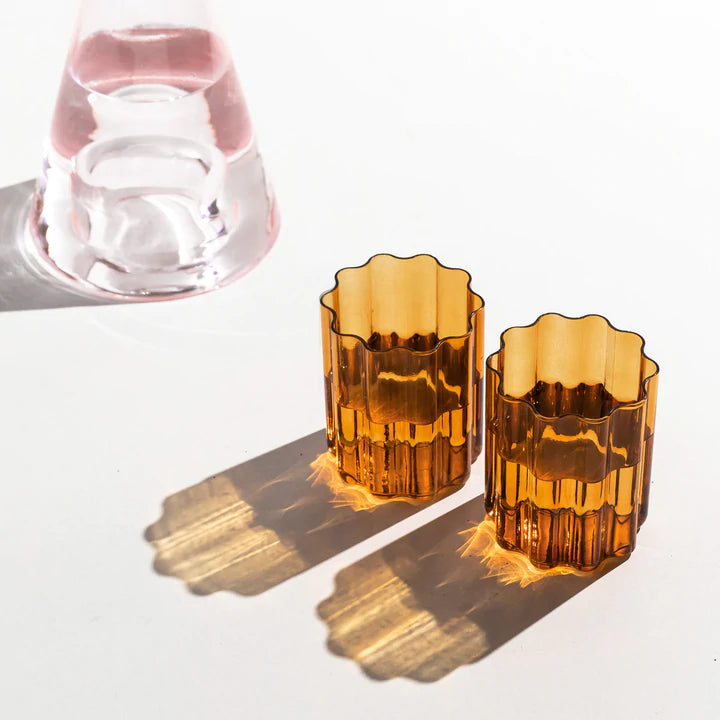 Fazeek Wave Glasses in Amber staged with water in them and decanter