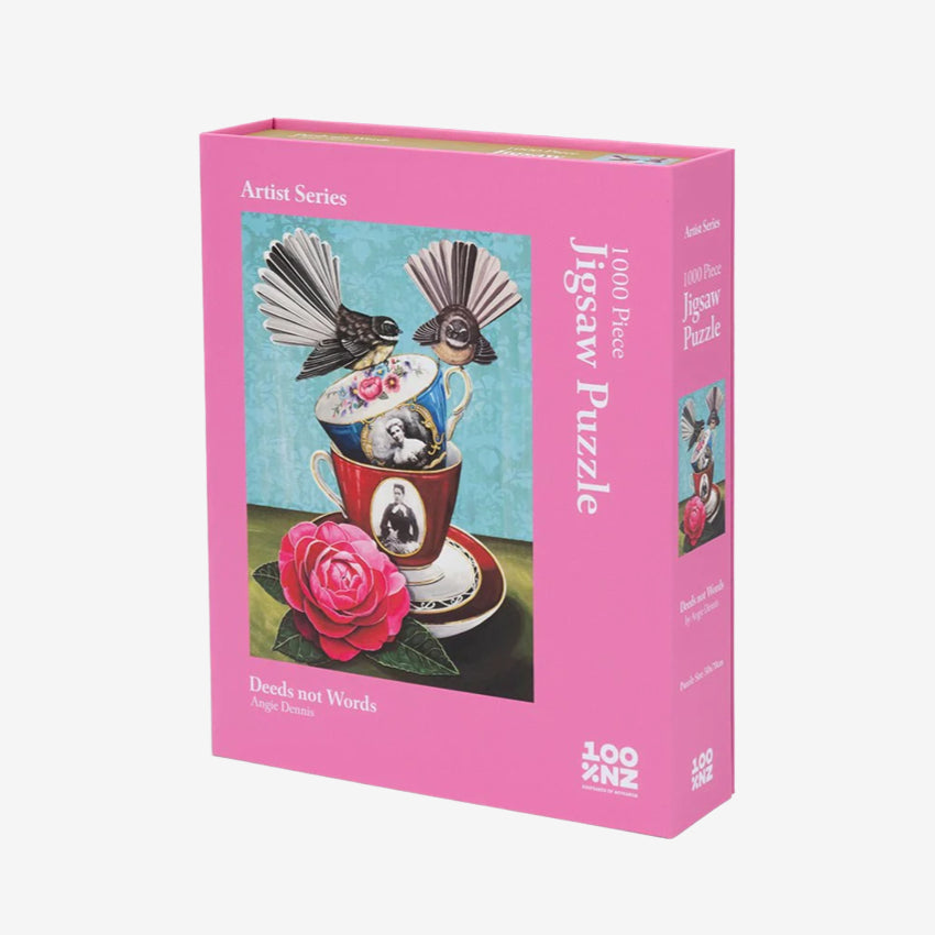 A 100 Percent NZ Jigsaw Puzzle in a pink box with artwork of birds and a teacup by Angie Dennis
