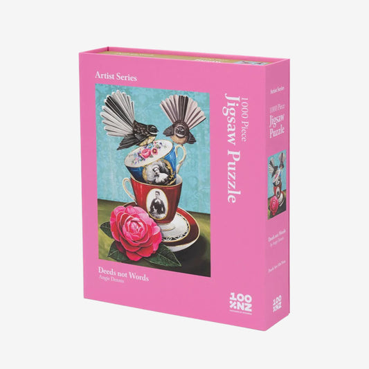 A 100 Percent NZ Jigsaw Puzzle in a pink box with artwork of birds and a teacup by Angie Dennis
