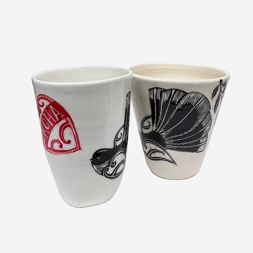 Two of the Amber Smith Piwakawaka and Tui Cups on a blank background 