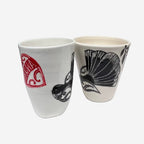 Two of the Amber Smith Piwakawaka and Tui Cups on a blank background 
