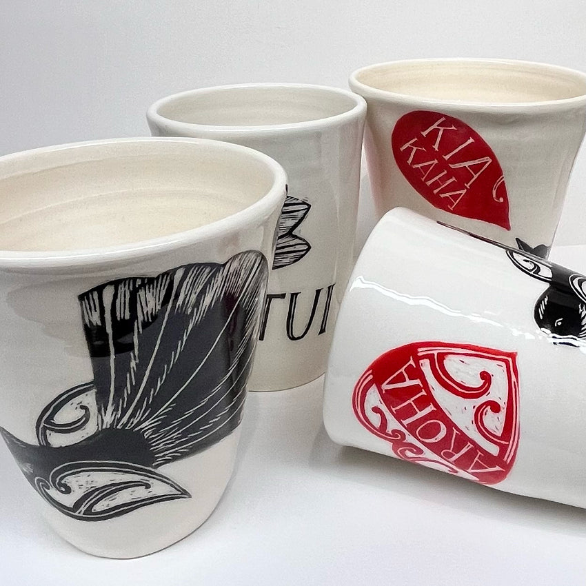 4 of the Amber Smith Piwakawaka and Tui Cups on a blank background 