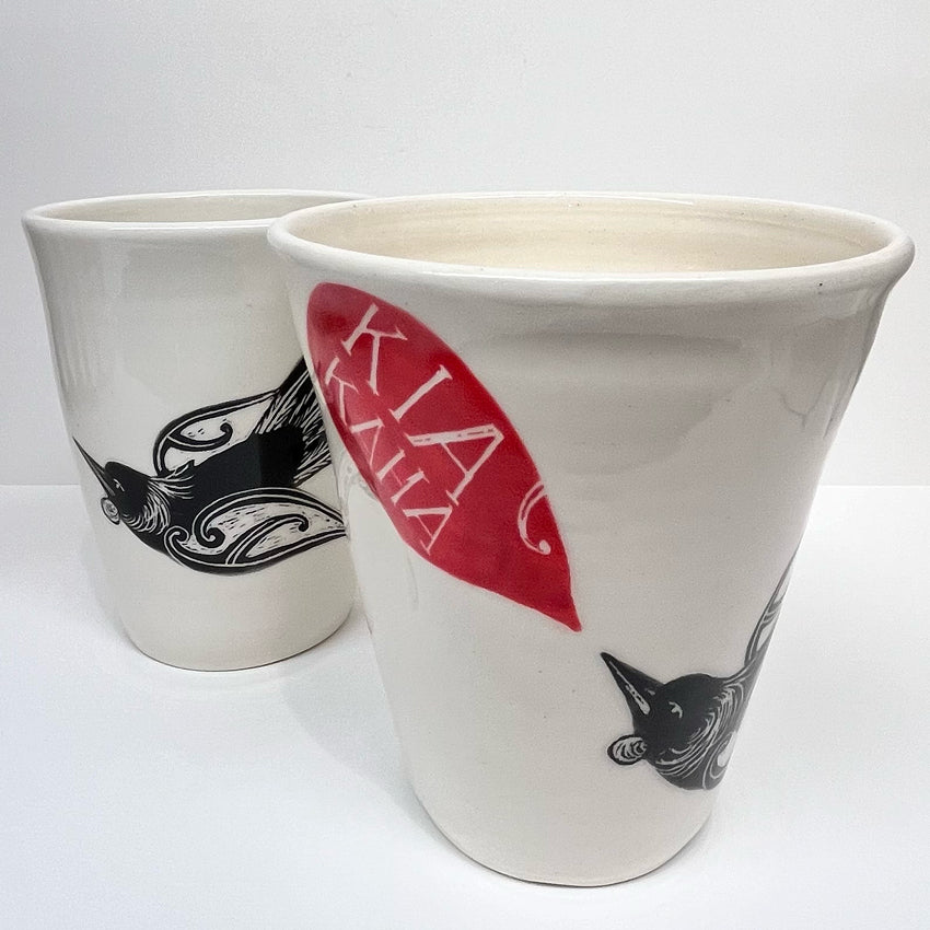 Two of the Amber Smith Piwakawaka and Tui Cups on a blank background 