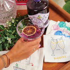 The Annabel Trends Cocktail Napkins on tray with gin and a coktail