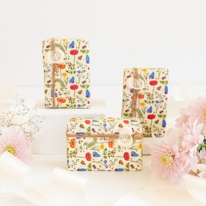 The Anoint Baby Shea Butter Soap Bars in a styled shot with flowers and ribbons
