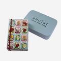 The Anoint Rose Geranium Lotion Bar next to its tin on a blank background