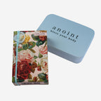 The Anoint Ylang Ylang and Grapefruit Lotion bar with tin on a blank background