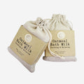 Two of the Anoint Oatmeal Bath Milks on a blank background