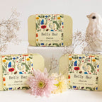 Three of the Anoint Belly Bar in tins in a staged shot