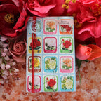 The Anoint Rose Geranium Lotion Bar on a bed of salts and flowers
