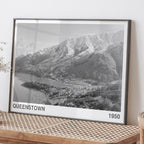The ARTORY Queenstown 1950 Art Print in a black frame on a bench