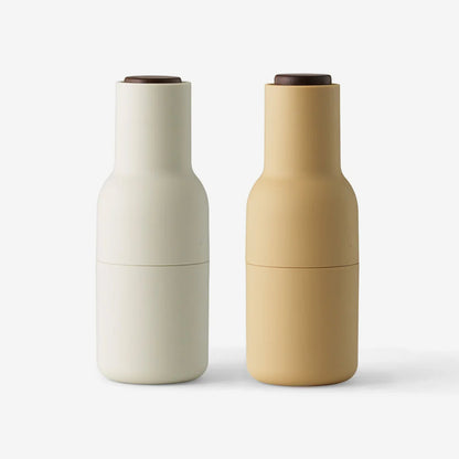 The Audo previously known as Menu Salt and Pepper Bottle Grinders in Barley with Walnut Lids on a blank background