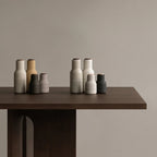 The small Audo Salt and Pepper Grinders in Ash, Carbon and Beech on a table with other Audo Salt and Pepper grinders.