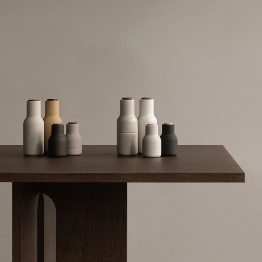 The small Audo Salt and Pepper Grinders in Ash, Carbon and Beech on a table with other Audo Salt and Pepper grinders.