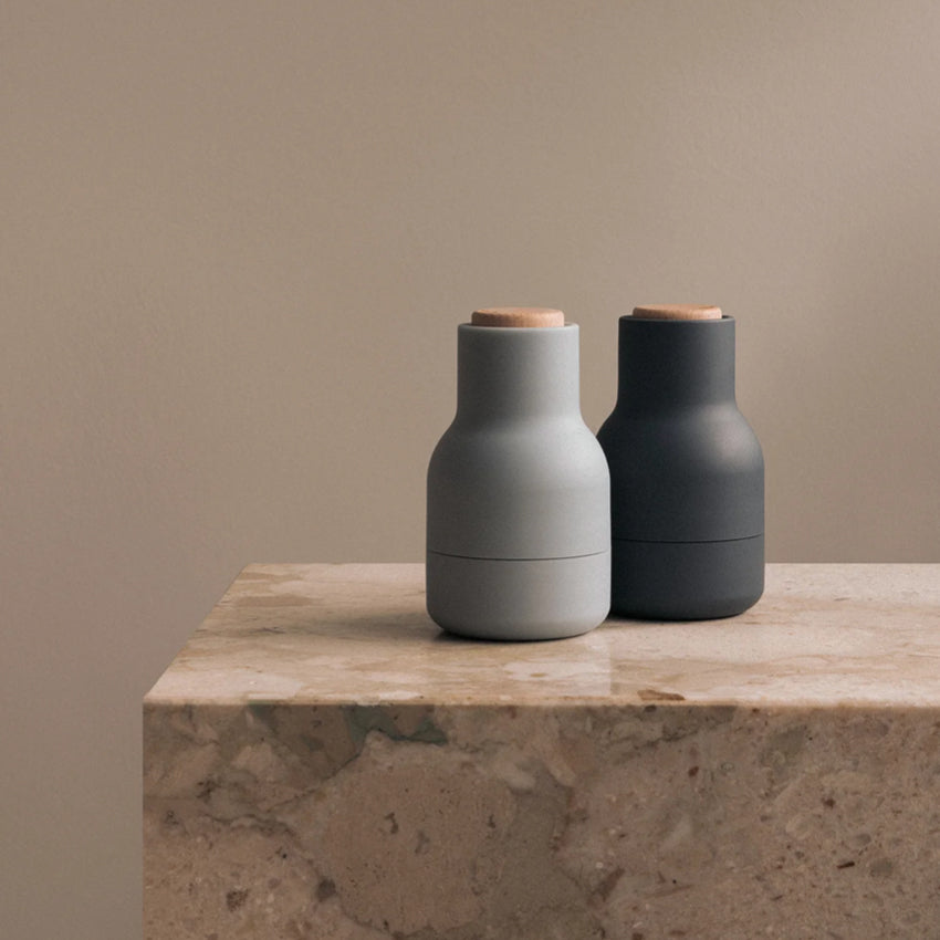 The Small Audo Salt and Pepper Grinder in Blues and Beech on a bench