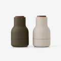 The Small Audo Salt and Pepper Grinder in Hunting Green and Walnut on a blank background