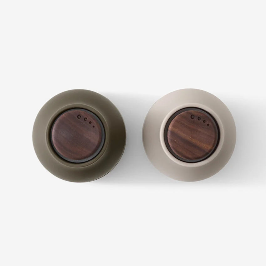 A top view of the small Audo Salt and Pepper Grinder in Hunting Green and Walnut on a blank background