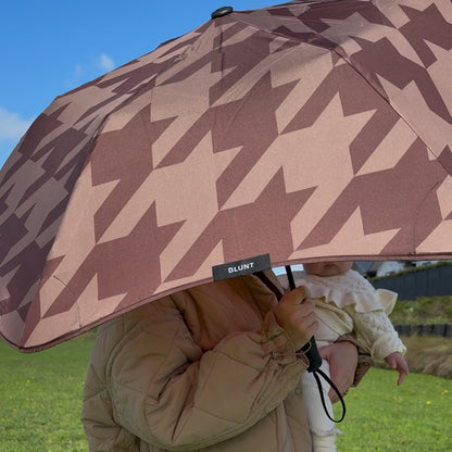 The Blunt Limited Edition Cocoa Metro Umbrella fully open being held up