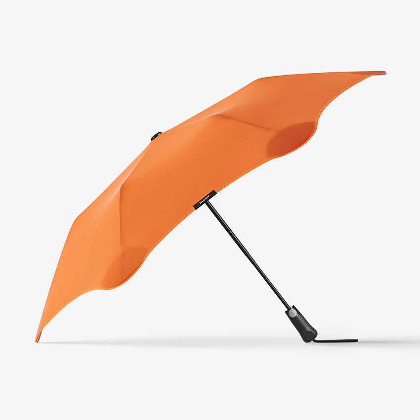 The Blunt Metro Umbrella in Orange on a blank background