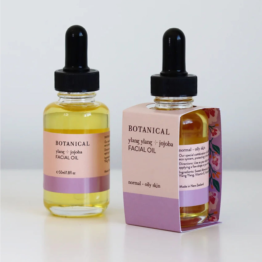 Two of the Botanical Ylang and Jojoba Facial Oils one in its packaging