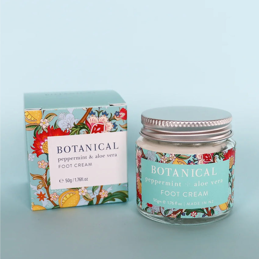 The Botanical Peppermint and Aloe Vera Foot Cream and its box on a blue background