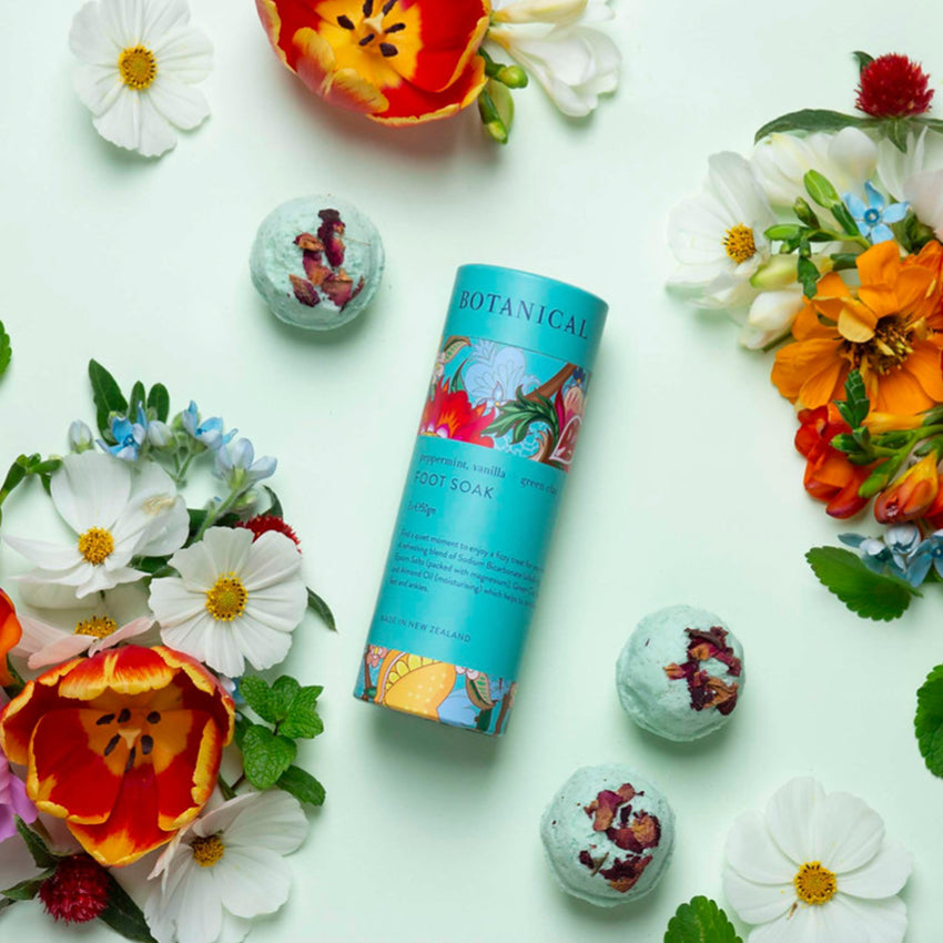 The Botanical Foot Soak Trio surrounded with flowers and the bombs