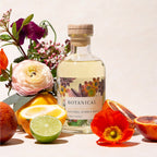 The Botanical Natural Bubble Bath surrounded with flowers and fruit